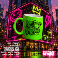 A bright neon green ceramic mug with black text reading 'Dyslexics Are People Poo' and star accents, shown in front of a city building with neon graffiti. Product text overlays and a 'SILLY DOG DESIGNS' logo appear on the image.