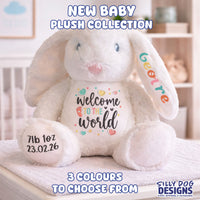 A white plush bunny toy with custom printed personalization on its belly and left ear, sitting on a bed in a softly blurred nursery setting. Text overlays read 'NEW BABY PLUSH COLLECTION', '3 COLOURS TO CHOOSE FROM', and the brand 'SILLY DOG DESIGNS'.